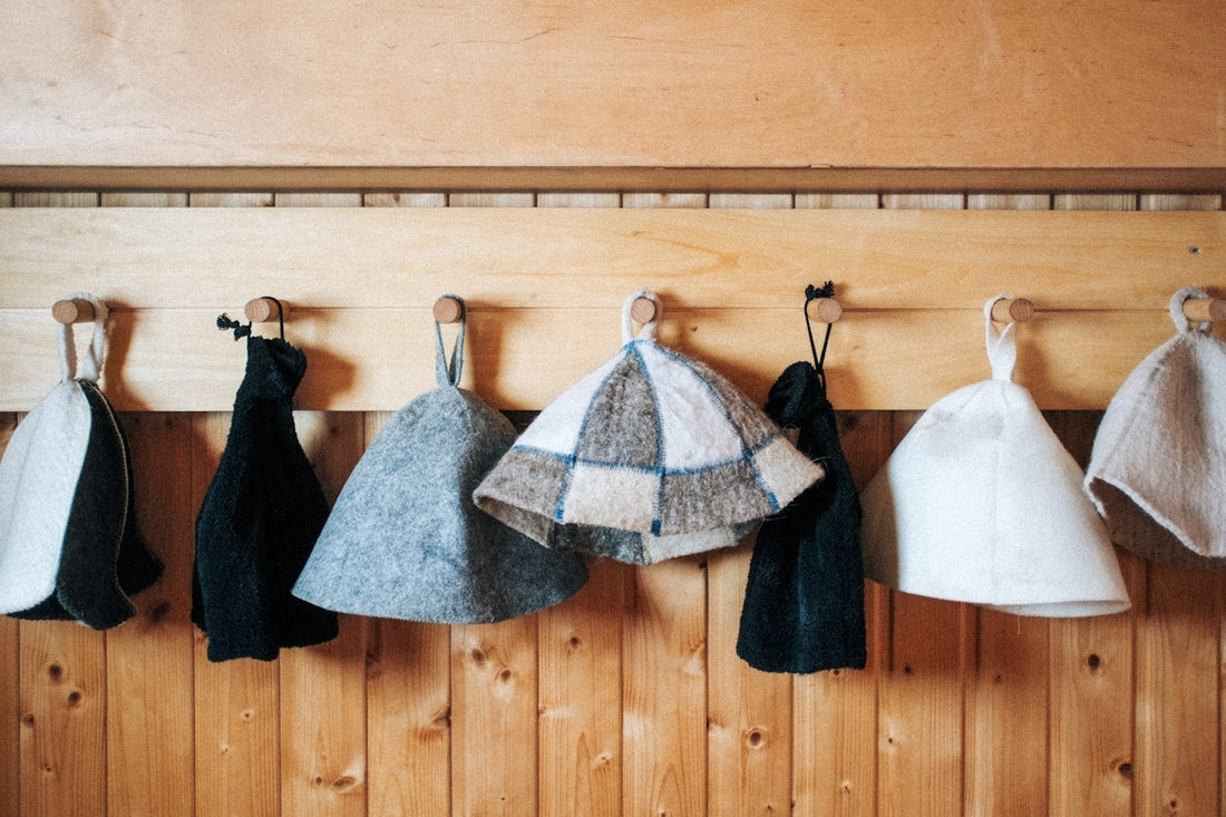 a row of towels hanging on a wooden wall