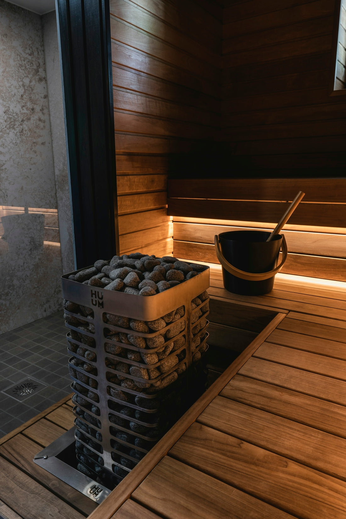 a bucket of rocks sitting on top of a wooden floor