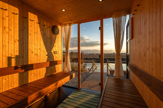 a wooden sauna with a view of a body of water