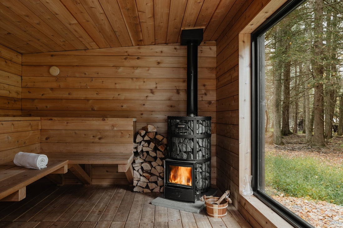 A wood burning stove inside of a wooden cabin