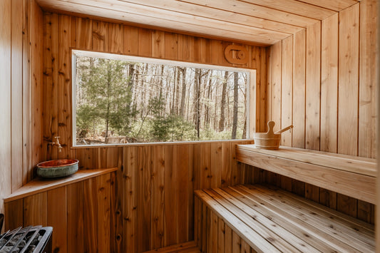 A wooden sauna overlooks a forest view.