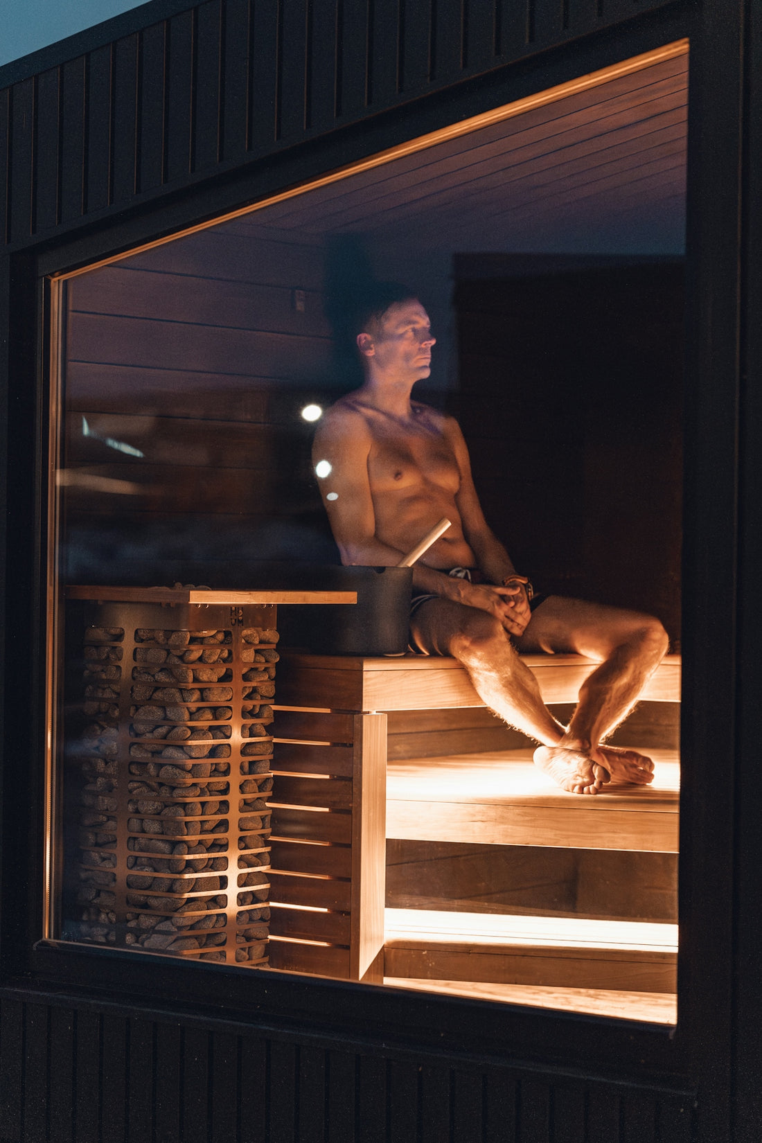 A man relaxing in a sauna.